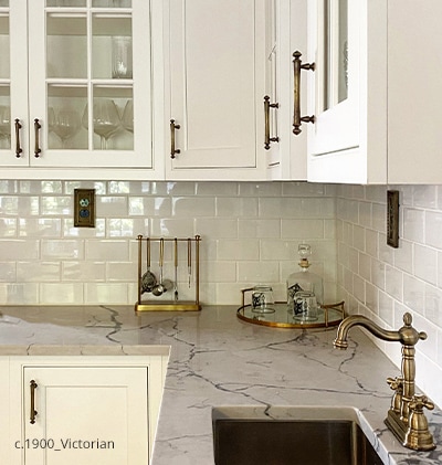 Kitchen cabinets with classical revival drawer pulls in Antique-by-Hand